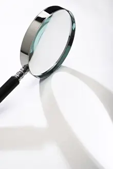Close Up Concept Image Imprime: Magnifying glass casting a shadow