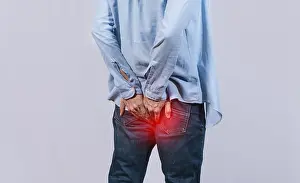Abdominal Pain Causes Imprime: Man with digestive problem touching his buttock