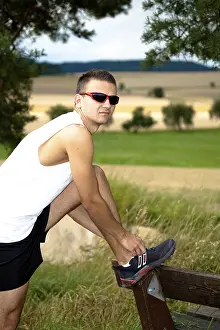 Outdoor Recreational Activity Imprime: Man jogging through the fields