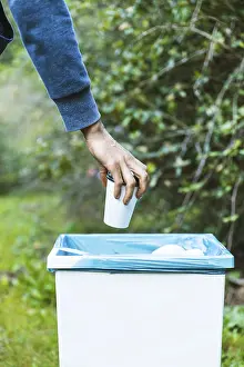 Waste Management Imprime: Man throwing up garbage bin