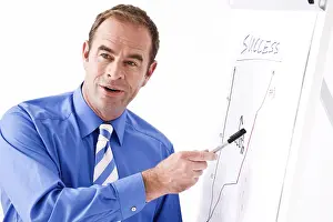 Middle Aged Man Portrait Imprime: Manager explaining something by using a flipchart