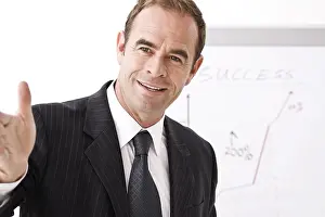 Middle Aged Man Imprime: Manager standing in front of a flipchart