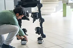 Exoskeleton Technology Imprime: Mechanical exoskeleton engineer checking robot before delivery to customer