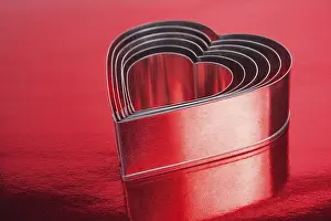 Symbolic Picture Imprime: Some of the metal hearts shaped over red background