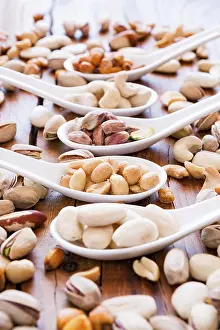 Deserted Table Scene Imprime: Mix of nuts over a rustic table in backlit