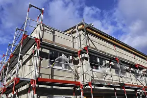 Residential Construction Site Imprime: New building with completed basic rendering of the exterior facade New building with completed basic rendering of