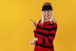 Yellow Background Cutout Imprime: Pointing to the left in a wool cap