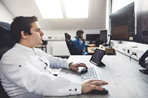 Computer Specialist Imprime: IT Programmer Working on Desktop Computer