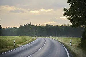 Southern Germany Weather Forecast Imprime: Road through fields and forests at sunset after rain