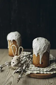 Traditional Easter Dessert Imprime: A rustic setup featuring two Kulich