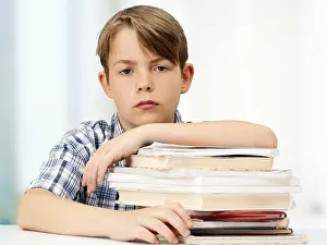 Caucasian Boy Portrait Imprime: Schoolboy with a stack of books, looking serious