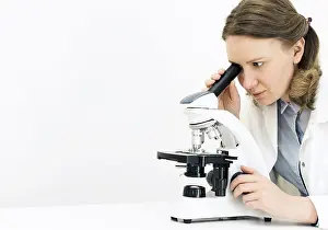 Virus Analysis Imprime: Scientist using microscope in laboratory