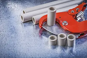 Metal Background Studio Shot Imprime: Set of pipe coupling tools on metallic background construction concept