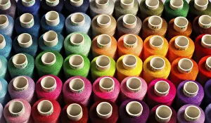 Multicolored Threads Imprime: Sewing threads as a multicolored background close up