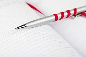 Uninhabited Office Space Decor Imprime: Silver pen on opened notebook with red string