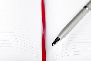 Office Supply Desk Utensils Imprime: Silver pen on opened notebook with red string