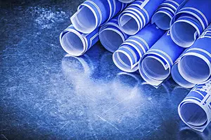 Close Up Construction Plan Imprime: Stack of blue engineering drawings on metallic background construction concept