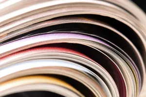 Environmental Conservation Through Reuse Imprime: Stack of open magazines