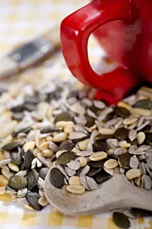 Single Person Baking Imprime: A table with several nuts and kernels