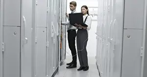 Healthcare Technology Imprime: Technicians using laptop while analyzing server in server room