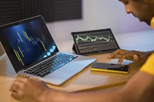Man Working From Home Imprime: Trader using computer and electronic devices to work in remote from home