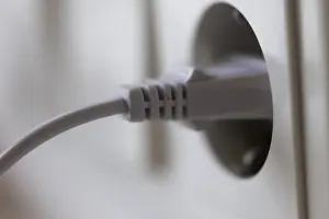 Energy Efficiency Concept Imprime: White power plug in a socket on the wall