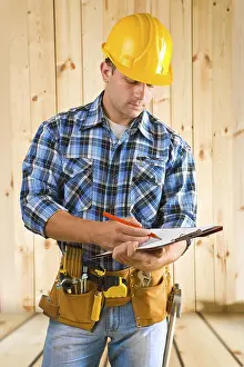 Young Engineer Imprime: Worker write on clipboard