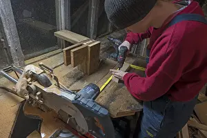 Central European Atmosphere Imprime: Young man working in his workshop in the evening
